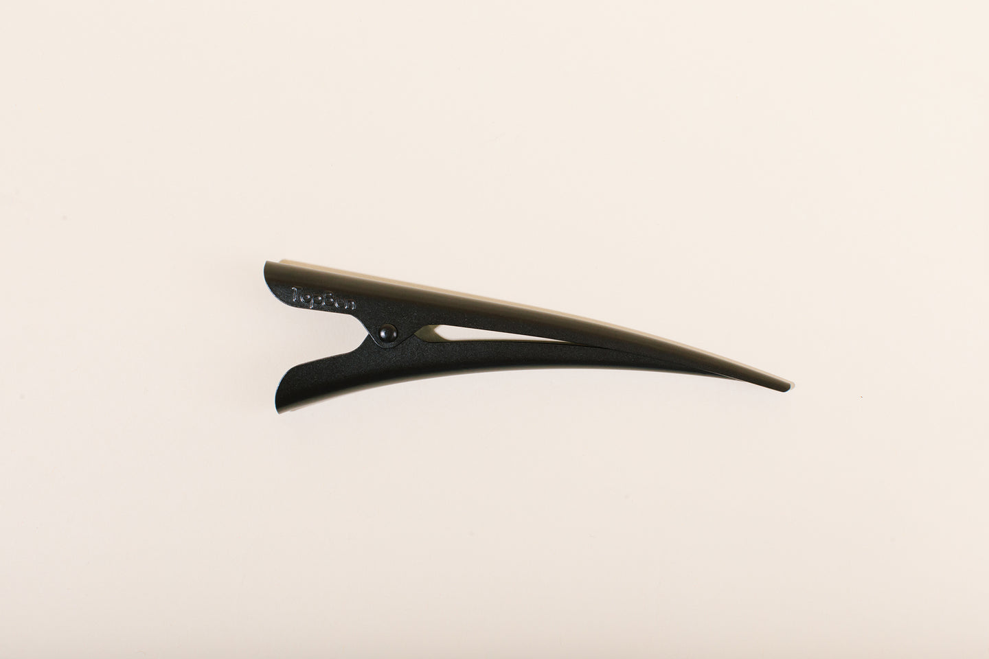 Black matte TopBun hair clip against neutral background