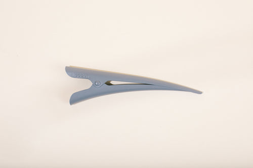 Gray matte TopBun hair clip against neutral background