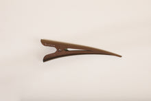 Medium brown TopBun hair clip against neutral background