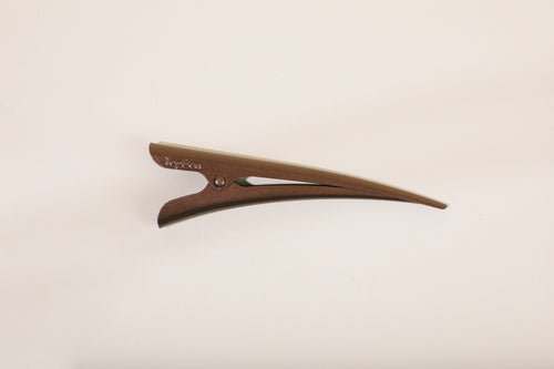 Medium brown TopBun hair clip against neutral background