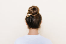 Golden Blonde TopBun hair clip shown holding a high bun in brunette hair