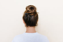 Dark brown TopBun hair clip shown holding a high bun in brunette hair