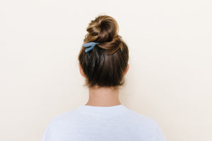 Gray matte TopBun hair clip shown holding a high bun in brunette hair